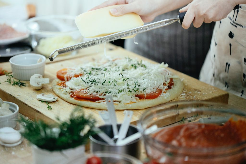 cheese on pizza which has been done by a cheese grater