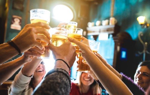 people cheering with beers in a pub in cambridge