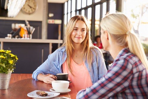 two girls having a coffee together