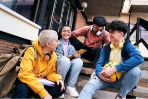 A group of students laughing and talking 