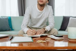Man sitting on a chair and budgeting 