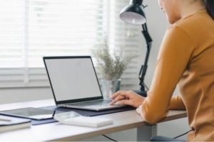 Girl typing on a laptop 