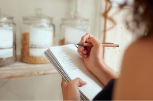 Girl writing on a book 